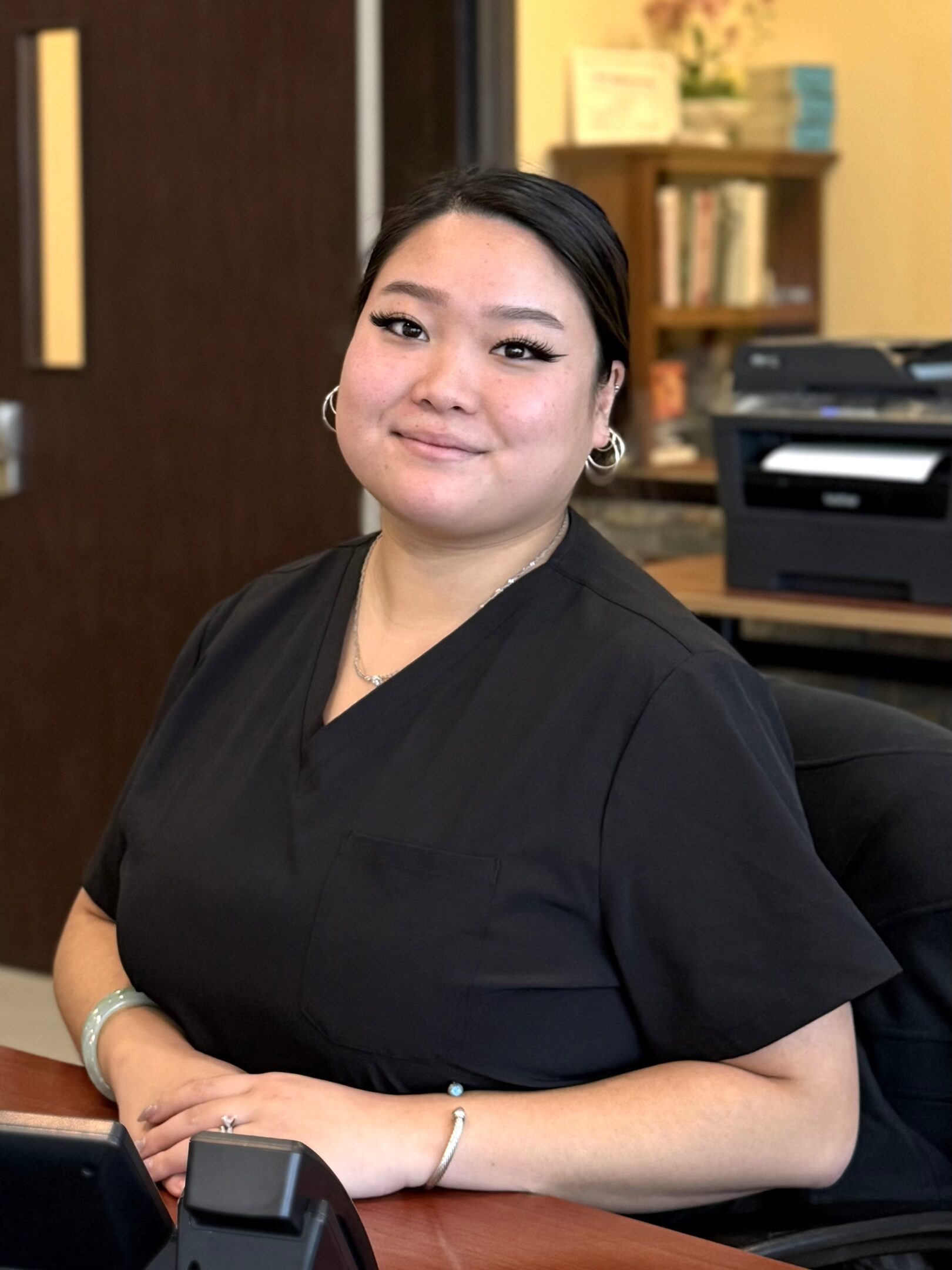 Woman in black attire at desk